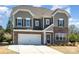 Charming two-story home featuring a stone facade, two-car garage, and inviting front entrance at 2248 Killian Creek Dr, Denver, NC 28037