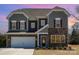 Charming two-story home with a stone facade, two-car garage, and classic architectural details at 2248 Killian Creek Dr, Denver, NC 28037