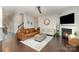 Cozy living room with a fireplace, hardwood floors, and comfortable seating, perfect for relaxing at 2248 Killian Creek Dr, Denver, NC 28037
