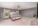 Spacious main bedroom with a comfortable king-size bed and soft, neutral tones at 2248 Killian Creek Dr, Denver, NC 28037