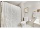 A bathroom with white shower curtains and a standard toilet at 236 Greendale Dr, Mount Holly, NC 28120
