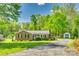 Charming single-story brick home with a lush green lawn and a long driveway at 236 Greendale Dr, Mount Holly, NC 28120