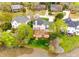 Aerial view of a home with a large deck overlooking a lake, surrounded by lush greenery and mature trees at 2515 Barrington Ct, Rock Hill, SC 29732