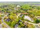 Aerial view of neighborhood with lush green trees, with lakefront homes and tree-lined streets in a residential community at 2515 Barrington Ct, Rock Hill, SC 29732
