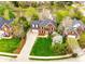 Aerial view of a home with a landscaped yard, mature trees, and a neighborhood pond at 2515 Barrington Ct, Rock Hill, SC 29732