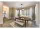 Lovely dining room with a wooden table, bench seating, and elegant light fixture at 2515 Barrington Ct, Rock Hill, SC 29732