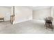Inviting bedroom featuring neutral carpeting, fresh paint, stairway access, and a cozy seating area at 2548 Flintshire Ln, Gastonia, NC 28056
