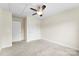 This bedroom features neutral carpeting, a ceiling fan, and two white doors at 2548 Flintshire Ln, Gastonia, NC 28056