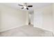 A bright bedroom includes neutral carpet, a ceiling fan, and access to other rooms at 2548 Flintshire Ln, Gastonia, NC 28056
