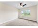 This carpeted bedroom features a ceiling fan and a window with a view of the outdoors at 2548 Flintshire Ln, Gastonia, NC 28056