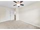 Carpeted bedroom featuring a ceiling fan, neutral walls, and bright window for natural light at 2548 Flintshire Ln, Gastonia, NC 28056