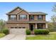 Charming two-story brick home with a covered porch and well-manicured landscaping at 2548 Flintshire Ln, Gastonia, NC 28056