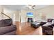 Spacious living room with hardwood floors, a cozy fireplace, and modern furnishings at 2548 Flintshire Ln, Gastonia, NC 28056