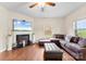 Comfortable living room featuring hardwood floors, a fireplace, and plush, stylish seating at 2548 Flintshire Ln, Gastonia, NC 28056