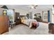 Carpeted main bedroom featuring a ceiling fan, windows and stylish matching furniture set at 2548 Flintshire Ln, Gastonia, NC 28056