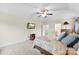 Cozy carpeted main bedroom featuring a ceiling fan, mounted television and neutral-toned walls at 2548 Flintshire Ln, Gastonia, NC 28056