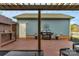Backyard patio with overhead awning, grill, and outdoor bar on the side of a blue two-story home at 3013 Kensley Dr, Waxhaw, NC 28173