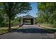 Scenic view of Millbridge's covered bridge entrance, surrounded by lush trees and landscaped walkway at 3013 Kensley Dr, Waxhaw, NC 28173