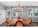 Charming dining room with an ornate chandelier and multiple windows at 3013 Kensley Dr, Waxhaw, NC 28173