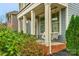 Inviting front porch with swing and beautiful landscaping at 3013 Kensley Dr, Waxhaw, NC 28173