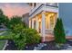 Inviting front porch features a swing and classic columns, offering a relaxing outdoor space at 3013 Kensley Dr, Waxhaw, NC 28173