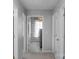 Hallway with a laundry room with washer and dryer, and three doors on either side at 3013 Kensley Dr, Waxhaw, NC 28173