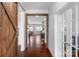 Elegant hallway with hardwood floors, wood door and shiplap walls at 3013 Kensley Dr, Waxhaw, NC 28173