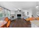 Open-concept living room features a fireplace, hardwood floors, and staircase leading to the second floor at 3013 Kensley Dr, Waxhaw, NC 28173