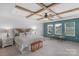 Main bedroom boasts a tray ceiling, wood beams, large windows, and a decorative headboard at 3013 Kensley Dr, Waxhaw, NC 28173