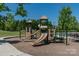 Community playground with slides and climbing features surrounded by a lush, green lawn at 3013 Kensley Dr, Waxhaw, NC 28173