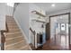 Carpeted staircase with decor shelving ascends to the second level, creating an inviting transition at 3013 Kensley Dr, Waxhaw, NC 28173