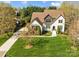 Aerial view of an elegant home with lush landscaping and a curved driveway on a sunny day at 318 Montrose Dr, Waxhaw, NC 28173