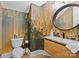 Striking bathroom with wallpaper accent wall, floating vanity, and black circular mirror at 318 Montrose Dr, Waxhaw, NC 28173