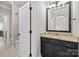 Bathroom with granite countertop, dark vanity, and an open doorway leading to the shower at 318 Montrose Dr, Waxhaw, NC 28173