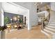 An open-concept dining room is showcased in front of the grand staircase and living room at 318 Montrose Dr, Waxhaw, NC 28173