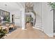 Open foyer featuring a grand staircase, elegant chandelier, and views into the dining and living areas at 318 Montrose Dr, Waxhaw, NC 28173