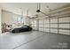 Well-organized garage with ample storage, epoxy flooring, and space for multiple vehicles and accessories at 318 Montrose Dr, Waxhaw, NC 28173