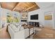 Bright living room with hardwood floors, stone fireplace, and wood beam ceiling at 318 Montrose Dr, Waxhaw, NC 28173