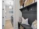 Functional mudroom with built-in storage, hooks, and a view into the laundry area for added convenience at 318 Montrose Dr, Waxhaw, NC 28173