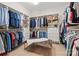 Spacious walk-in closet with custom shelving, drawers, and leather bench with white shag rug at 318 Montrose Dr, Waxhaw, NC 28173