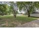 Large, grassy backyard with mature trees and a privacy fence at 35 E Catawba St, Belmont, NC 28012