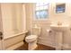 Classic bathroom with clawfoot tub, pedestal sink, and vintage-style fixtures at 35 E Catawba St, Belmont, NC 28012
