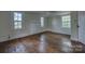 Light-filled bedroom with hardwood floors, ceiling fan, and large windows at 35 E Catawba St, Belmont, NC 28012