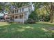 Charming two-story home with a front porch, mature trees, and a detached garage at 35 E Catawba St, Belmont, NC 28012