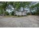 Charming white home featuring mature trees and a spacious driveway at 35 E Catawba St, Belmont, NC 28012
