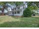 Charming two-story house with a welcoming front porch, lush lawn, and mature trees at 35 E Catawba St, Belmont, NC 28012