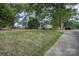 Traditional two-story home with a covered front porch and mature trees at 35 E Catawba St, Belmont, NC 28012