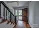 Inviting foyer with hardwood floors, staircase, and a glimpse of the outdoors through the open front door at 35 E Catawba St, Belmont, NC 28012