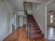 Inviting hallway featuring a carpeted staircase and classic wood trim at 35 E Catawba St, Belmont, NC 28012