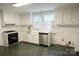 Well-lit kitchen featuring white cabinets and a stainless steel dishwasher at 35 E Catawba St, Belmont, NC 28012
